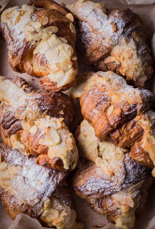 Croissants with almonds, vertical top view