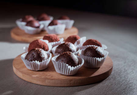 Chocolate truffles candy on wooden table, soft focus.の写真素材