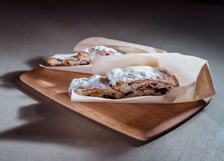 Cake with nuts and sugar on wooden table in cafe.の写真素材