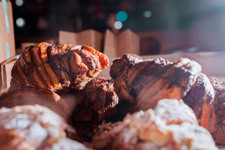 Sweet Chocolate Croissants selective focus on wooden background.の写真素材