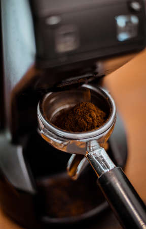 Coffee grinder soft focus and holder with coffee, background for cafeの写真素材