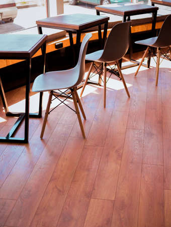 wooden chairs and tables in cafeの写真素材