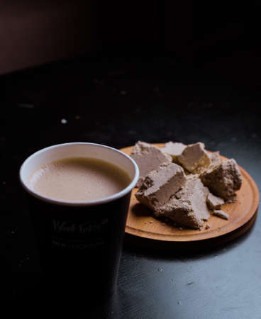 Cup of coffee with sweet on black background,soft focusの写真素材