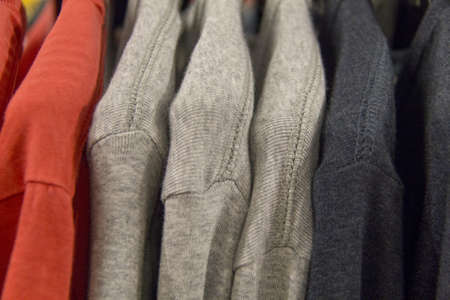 Colorful t-shirts on a shopping rack の写真素材