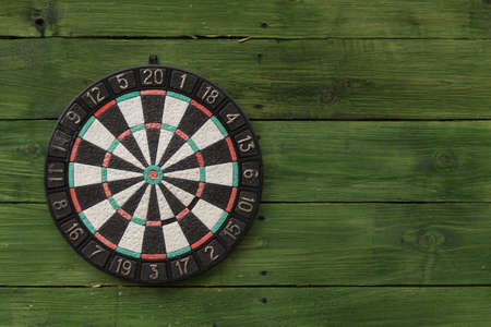 Dart board on a green wooden wallの写真素材