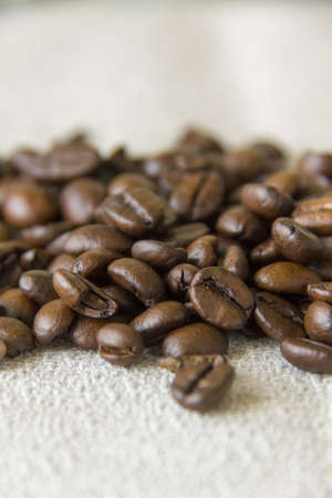 Fresh whole coffee beans on a grey clothの写真素材