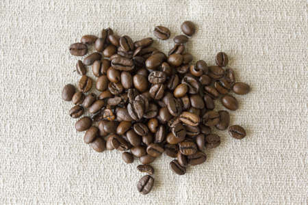 Fresh whole coffee beans on a grey clothの写真素材