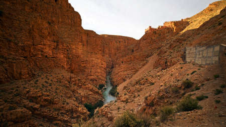 Wide canyon with a small stream flowing down the gorgeの写真素材