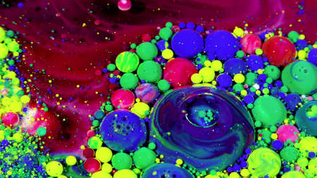 Many colored balls of different sizes lie in a chaotic order on a colored surface