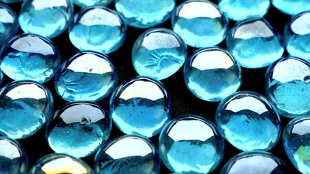 Many identical little hard blue balls touching each otherの写真素材