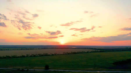 Beautiful sunny sunset on the open horizon over the fieldsの写真素材