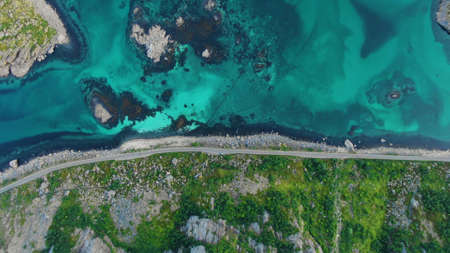 Top view of the road between the mountain with turquoise water in the bay between the Lofoten Islandsの写真素材
