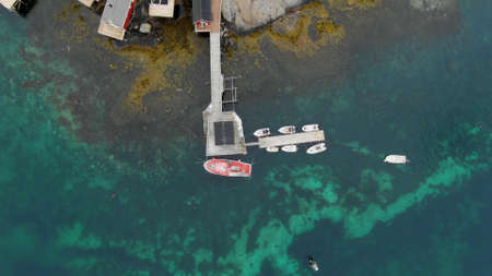 Top view of a small boat marina on an island with emerald-colored waterの写真素材