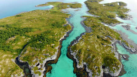 Top view of small islands surrounded by bright turquoise water in betweenの写真素材
