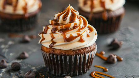 Delicious cupcakes with caramel on table, closeup. Delicious dessertの素材