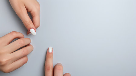 Manicure and pedicure. Woman hands with white nail design.の素材