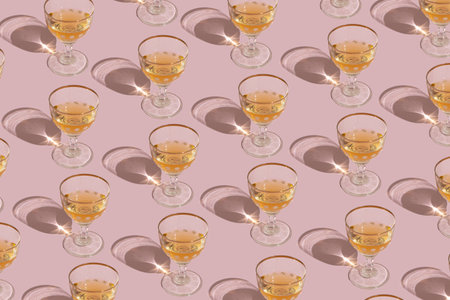 Shiny glasses on an pastel pink background. Creative pattern.の写真素材