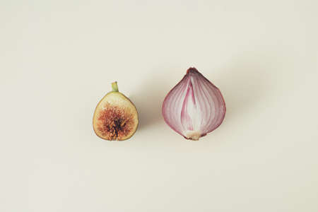 Natural seasonal minimal layout with autumn fig and purple onion.  Flat lay, on white background.の写真素材