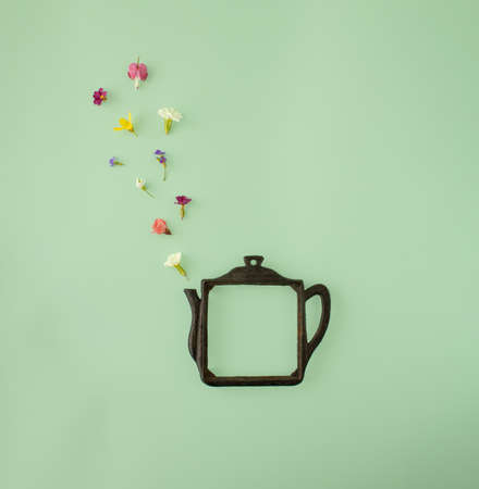 Elegant and retro teapot shaped frame , with colorful spring flowers. Minimal copyspace concept...