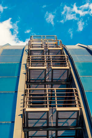 futuristic building with mirrored facade in blue
