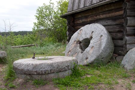 Two ancient millstones near the windmill wall
