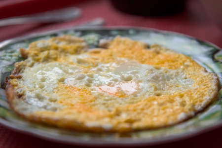 Fried omelette on a plate on tray homemade.の写真素材