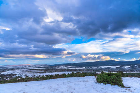 Dramatic sky landscape. Beautiful mountain view. Evergreen juniper.