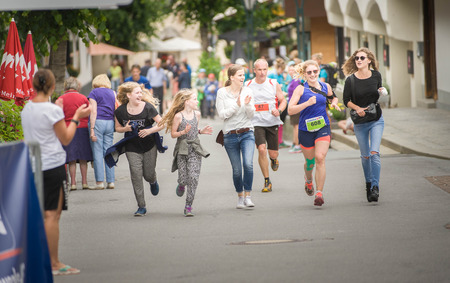 AUSTRIA, ST. ANTON AM ARLBERG - JULI 2, 2016: Woman running with friends to finish the Trail Run (part of the 14th Montafon Arlberg Marathon)のeditorial素材