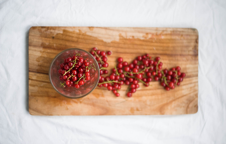 Red Currant in the Glass on Wooden Background. View from above. Seasonal Fruit.の写真素材