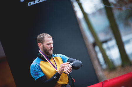 Czech Republic, Pilsen, November 2018: Hannah Pilsen Trail Krkavec. Runner Checking the Sport Watches at the Finish of the Race.のeditorial素材