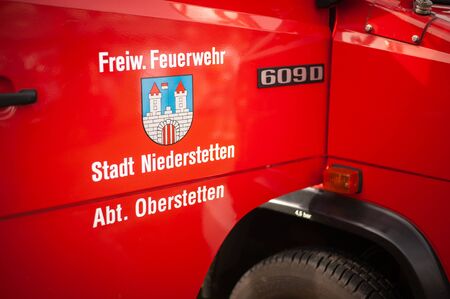 Germany, Baden Wurttemberg, Niederstetten. September 2019. Door of firefighters truck with text Freiw. Feuerwehr Stadt Niederstetten Abt. Oberstetten, in English volunteer firefighters from Oberstetten.のeditorial素材