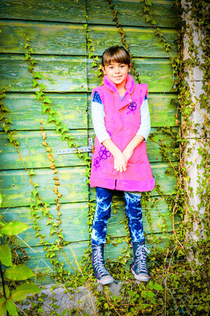 Little girl standing in front of the doorsの写真素材