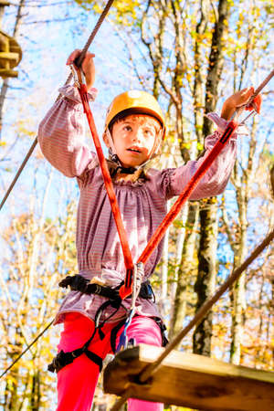 Little girl climbing in adventure parkの写真素材
