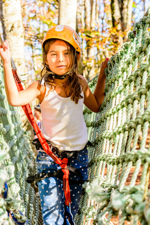 Little girl climbing in adventure parkの写真素材