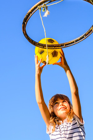 Seven year old girl is playing basketballの写真素材