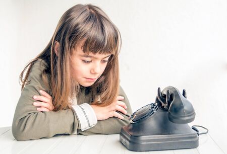 Little girl waiting for the phone to ringの写真素材