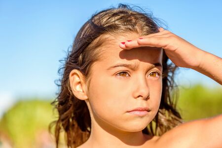 Beautiful little girl looking  far awayの写真素材