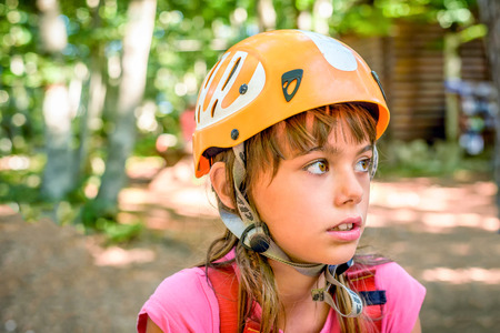 Profile of a beautiful eight year old girl in adventure parkの写真素材