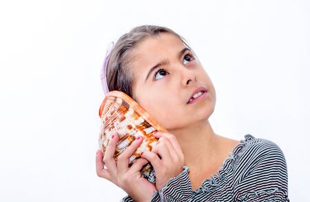 Little girl holding a sea shell