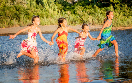 Four little girls having fun in the water in Ada bojana, Montenegroの写真素材