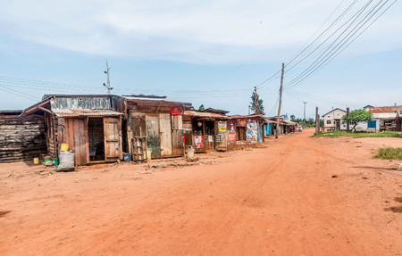 Bukoba,Tanzania-March 28, 2016: Dirt road with stores and houses in Bukoba, Tanzaniaのeditorial素材