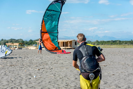 Ulcinj, Montenegro- July 18, 2016: Kitesurfer trying to lift his power Kite in the air on the beach in Ulcinj, Montenegroのeditorial素材