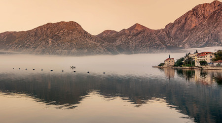 Village at Boka Kotor Bay in the morning fog, Montenegro