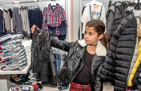 Tivat,Montenegro- November 5, 2016: Beautiful  happy  little girl shopping in retail storeのeditorial素材