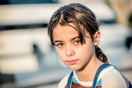 Portrait of a beautiful little girl looking at the cameraの写真素材