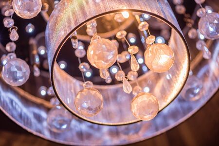 A cut glass chandeliere closeup at nightの写真素材