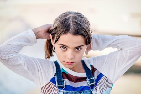 Portrait of a beautiful little girl looking at the cameraの写真素材