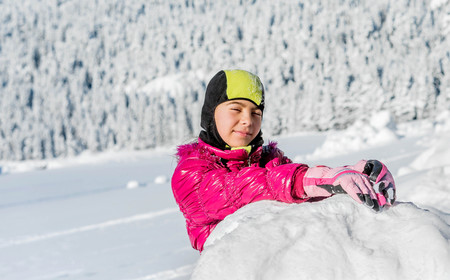Little girl playing in snow in Montenegro
