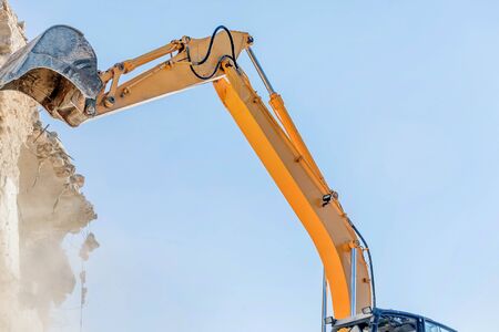 Demolition of an old house with excavator