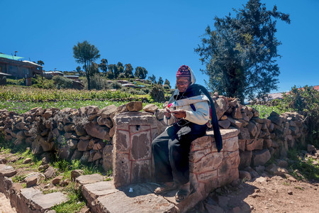 Peruvian man knitting on Taquile island neer Puno, Peruのeditorial素材